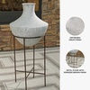 image:imageSignature Design by Ashley Estonbank Vase Distressed Cream Metal Floor Vase with Espresso Brown Stand for Faux Florals amp Seasonal Indoor Outdoor Decor 1413 W x 1413 D x 285 H1525 W x 1525 D x 35 H